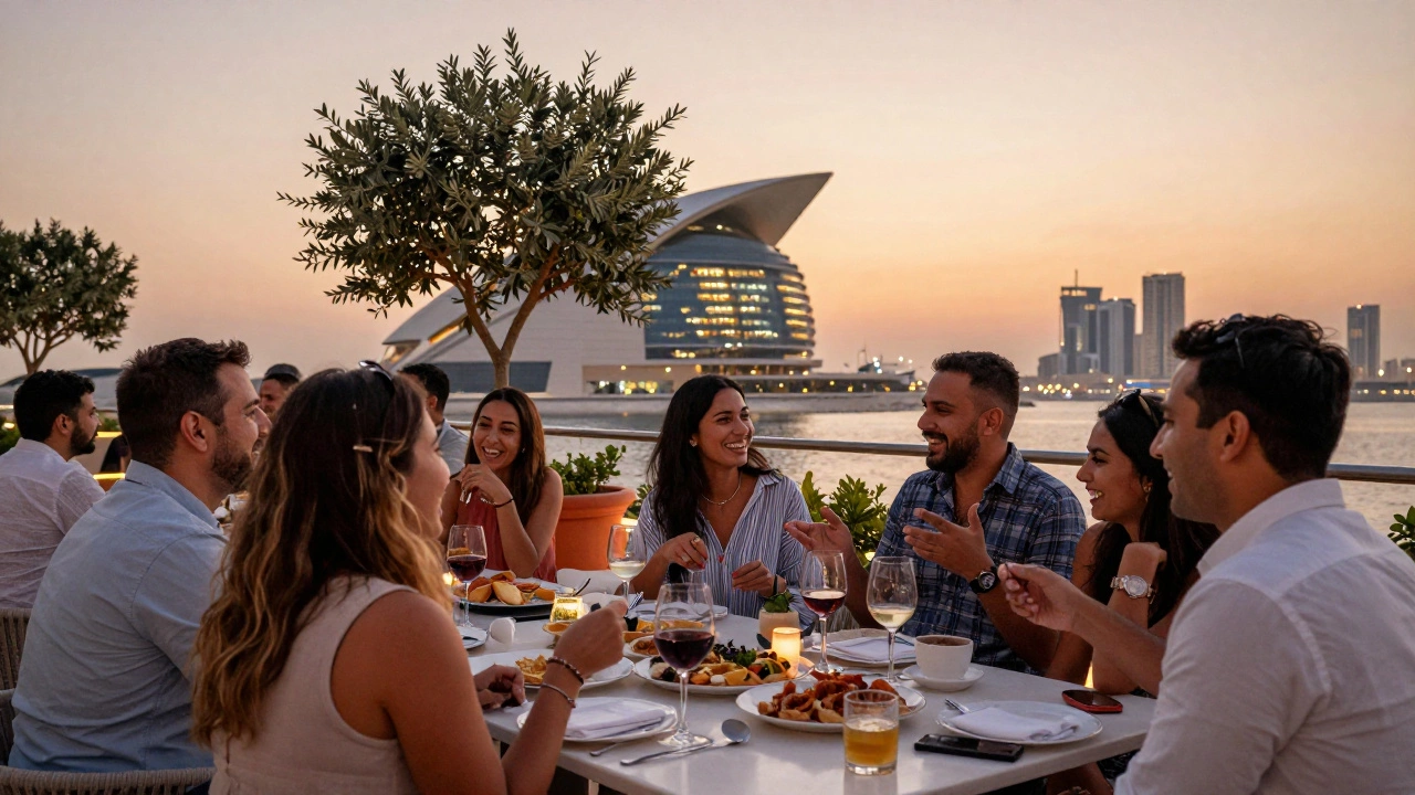 Diverse expats socializing at an outdoor terrace event in Dubai, laughing and talking over drinks at sunset.
